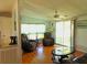 Comfortable living room with hardwood floors, recliners and large windows at 6246 Parakeet Rd, Englewood, FL 34224