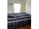 Guest bedroom with full-size bed and window at 6246 Parakeet Rd, Englewood, FL 34224
