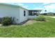 Side yard with grassy area and some shrubs at 6246 Parakeet Rd, Englewood, FL 34224