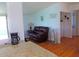 Open living area with hardwood floors, a couch, and access to the kitchen at 6246 Parakeet Rd, Englewood, FL 34224