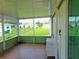Screened porch with tiled floor and view of backyard at 6246 Parakeet Rd, Englewood, FL 34224