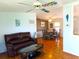 Bright living room with hardwood floors, leather furniture, and decorative accents at 6246 Parakeet Rd, Englewood, FL 34224