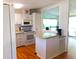 Bright kitchen features white cabinets, modern appliances, and a breakfast bar at 6246 Parakeet Rd, Englewood, FL 34224
