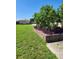 Spacious backyard with lush landscaping and a storage shed at 1455 Crest Dr, Englewood, FL 34223