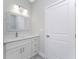 Bathroom with white vanity and a framed mirror at 213 Antis Dr, Rotonda West, FL 33947