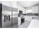 Modern kitchen with stainless steel appliances and white cabinets at 213 Antis Dr, Rotonda West, FL 33947