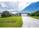 New construction home with paver driveway and landscaping at 213 Antis Dr, Rotonda West, FL 33947