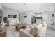 Open living room and kitchen with light, neutral decor at 213 Antis Dr, Rotonda West, FL 33947