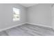 Simple bedroom with gray walls and wood-look flooring at 213 Antis Dr, Rotonda West, FL 33947