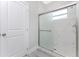 Walk-in shower with marble tile and glass enclosure at 213 Antis Dr, Rotonda West, FL 33947
