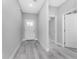 Bright entryway with gray wood-look floors and white doors at 213 Antis Dr, Rotonda West, FL 33947