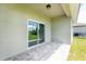 Covered patio with sliding glass doors and grey pavers at 213 Antis Dr, Rotonda West, FL 33947