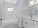 Bathroom with marble-look shower and white vanity at 213 Antis Dr, Rotonda West, FL 33947