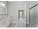 Modern bathroom with white vanity, grey flooring, and a walk-in shower at 213 Antis Dr, Rotonda West, FL 33947