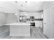 Modern kitchen with stainless steel appliances and white cabinetry at 213 Antis Dr, Rotonda West, FL 33947