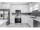 Modern kitchen featuring stainless steel appliances and white cabinetry at 213 Antis Dr, Rotonda West, FL 33947