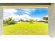 Spacious backyard with lush grass and a view of neighboring homes at 213 Antis Dr, Rotonda West, FL 33947