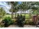 Peaceful patio with tropical plants and golf course view at 420 Cerromar Ct # 165, Venice, FL 34293