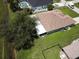 Expansive backyard features a screened lanai, mature tree, and a fenced area, offering outdoor living at 35 Mark Twain Ln, Rotonda West, FL 33947