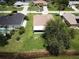 Sprawling property showcases lush lawn, mature trees, screened lanai, and a desirable waterfront location at 35 Mark Twain Ln, Rotonda West, FL 33947
