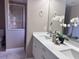 Bathroom featuring double sinks, quartz countertop, and a glass shower at 35 Mark Twain Ln, Rotonda West, FL 33947