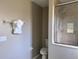 Clean bathroom with tiled shower, neutral walls, white toilet, and convenient towel rack at 35 Mark Twain Ln, Rotonda West, FL 33947