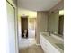 Bathroom showing double vanity, tiled flooring, and walk in shower at 35 Mark Twain Ln, Rotonda West, FL 33947