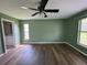 Spacious bedroom features wood flooring, a ceiling fan, and access to the ensuite bathroom at 35 Mark Twain Ln, Rotonda West, FL 33947