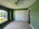 Bright bedroom with light tile floors, a fan, and double door closet at 35 Mark Twain Ln, Rotonda West, FL 33947