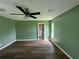 Bedroom features wood flooring, a ceiling fan, and a view of the ensuite bathroom at 35 Mark Twain Ln, Rotonda West, FL 33947