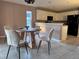 Inviting dining area with a round table, comfortable seating, and easy access to the kitchen at 35 Mark Twain Ln, Rotonda West, FL 33947