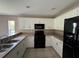 Functional kitchen with white cabinets, an appliance package, and ample counter space at 35 Mark Twain Ln, Rotonda West, FL 33947