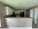 Kitchen with white cabinets, black appliances, and a breakfast bar at 35 Mark Twain Ln, Rotonda West, FL 33947