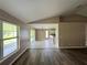 Bright living room area featuring wood floors, sliding glass doors, and a vaulted ceiling at 35 Mark Twain Ln, Rotonda West, FL 33947