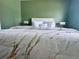 Serene bedroom with a king bed, modern lamps, and accent wall creating a relaxing retreat at 35 Mark Twain Ln, Rotonda West, FL 33947