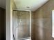 Tiled shower with glass door and chrome fixtures at 35 Mark Twain Ln, Rotonda West, FL 33947