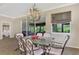 Elegant dining room with granite table, chandelier, and access to screened patio at 5229 Canyonland Way, Venice, FL 34293