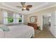 Spacious main bedroom with ceiling fan, dresser, and access to bathroom at 5229 Canyonland Way, Venice, FL 34293