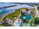 Aerial view showcasing resort-style amenities: pool, tennis court, and a tranquil pond at 6000 Boca Grande Cswy # D46, Boca Grande, FL 33921