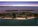 Breathtaking aerial view featuring waterfront residences, a community pool, and beach access at 6000 Boca Grande Cswy # D46, Boca Grande, FL 33921