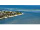 Picturesque aerial view of waterfront homes nestled among lush palm trees along the shoreline at 6000 Boca Grande Cswy # D46, Boca Grande, FL 33921