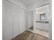 Bright bathroom featuring wood-look floors, large closet, and vanity with marble counter at 6000 Boca Grande Cswy # D46, Boca Grande, FL 33921