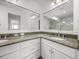 Bathroom featuring double sinks, granite countertops, and custom cabinetry at 6000 Boca Grande Cswy # D46, Boca Grande, FL 33921