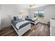 Inviting bedroom with two beds, white furnishings, a bright window and wood-look floors at 6000 Boca Grande Cswy # D46, Boca Grande, FL 33921