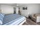 Calm bedroom with a plush, striped bed, and a relaxing lounge area at 6000 Boca Grande Cswy # D46, Boca Grande, FL 33921