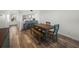 Cozy dining room with wood floors, a rustic table with bench seating, and views of the modern kitchen at 6000 Boca Grande Cswy # D46, Boca Grande, FL 33921