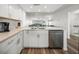 Modern kitchen with stainless steel appliances, sleek white cabinets, and elegant quartz countertops at 6000 Boca Grande Cswy # D46, Boca Grande, FL 33921