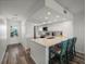 Well-lit kitchen features white cabinetry, stainless steel appliances, quartz countertops, and bar seating at 6000 Boca Grande Cswy # D46, Boca Grande, FL 33921