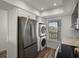 Bright kitchen featuring stainless steel appliances, modern cabinetry, and a convenient washer/dryer unit at 6000 Boca Grande Cswy # D46, Boca Grande, FL 33921