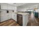 Open concept kitchen with stainless steel appliances, white cabinetry, and breakfast bar seating at 6000 Boca Grande Cswy # D46, Boca Grande, FL 33921